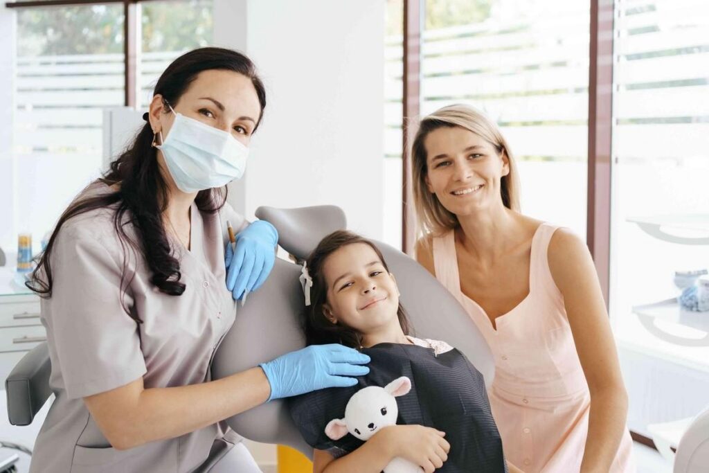 Family dentist welcoming a child and parent during a routine dental visit